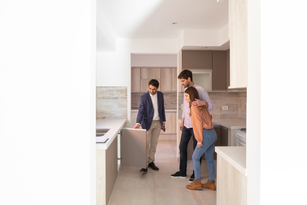 Real estate agent and family touring their new home